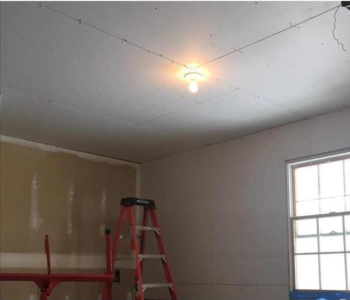 Garage with new sheetrock hung on walls and ceiling