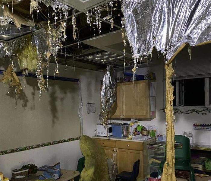 room with the ceiling and insulation falling down