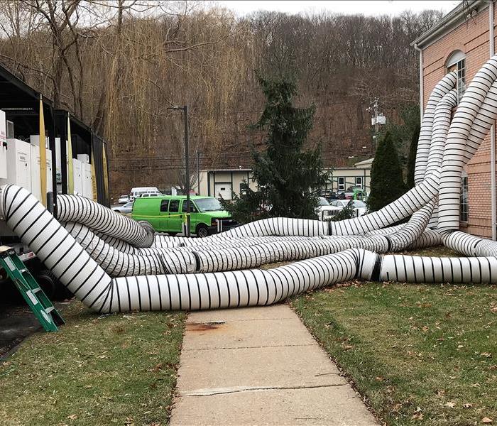 large ventilation tubes coming out of a building 